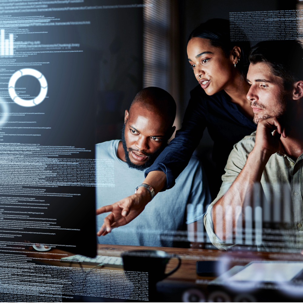 Three people looking at a computer screen